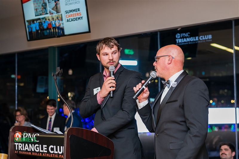 Scott on stage spotlighting a cause